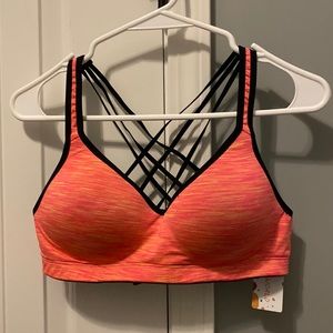Medium black and peachy colored sports bra